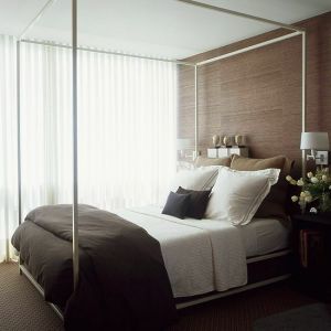 Luscious bedroom with brown accents including grasscloth wallpaper.jpg